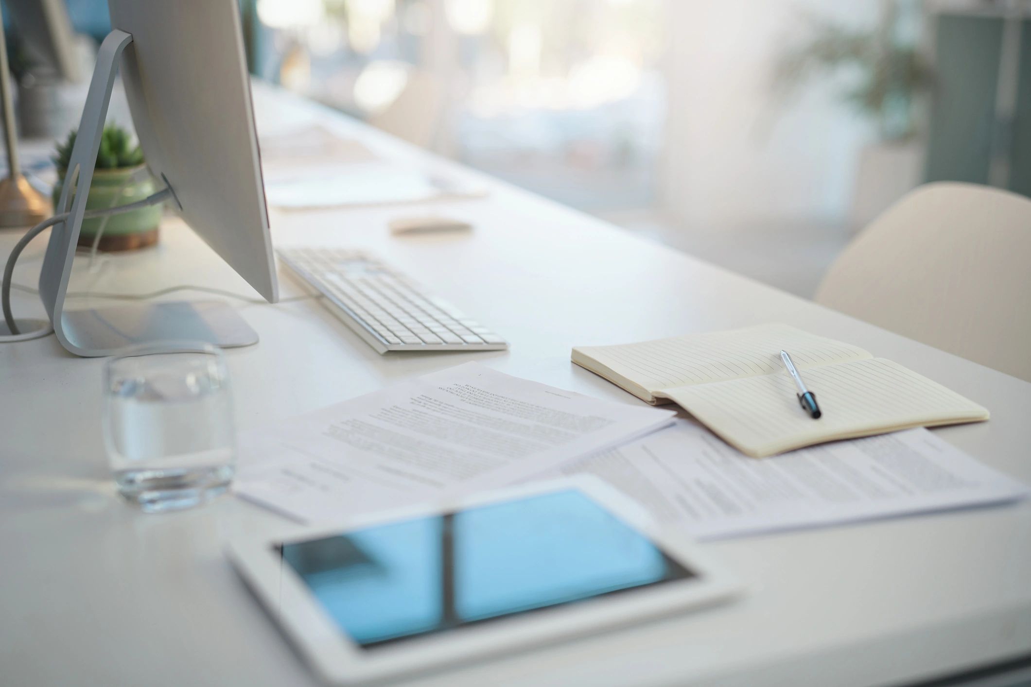 Compliance and contract documents on a modern office desk