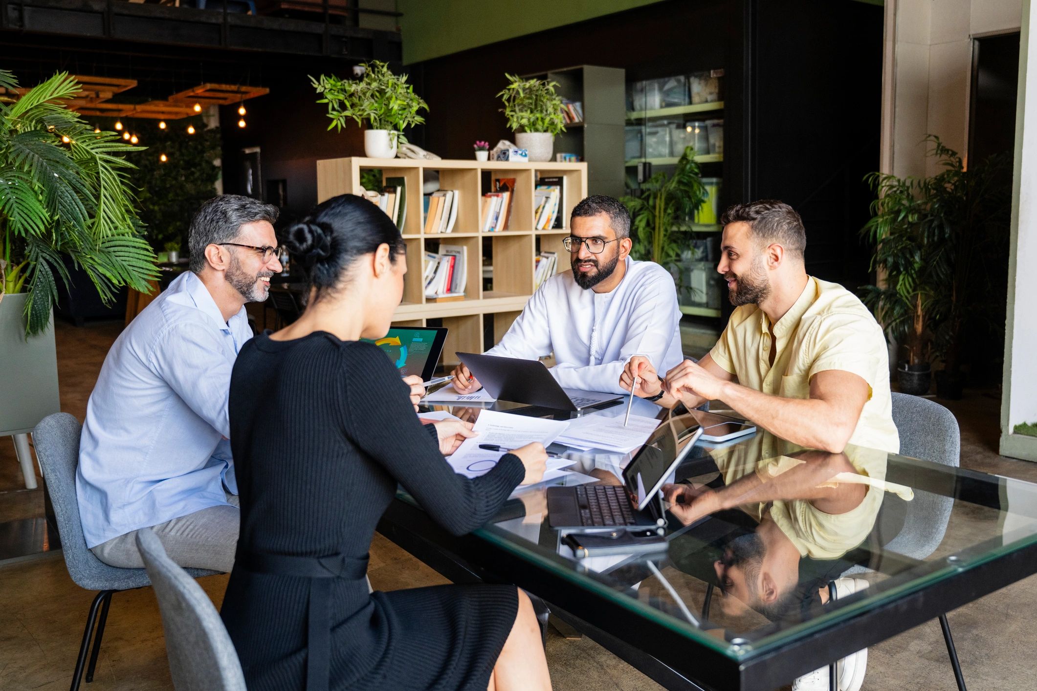 Team reviewing contract tasks and timelines in a modern office meeting